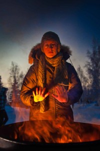 With temperatures near 35 below zero, Celia Miller warms her hands by the fire during the Honors Program week-long vigil in Constitution Park to draw attention to the plight of the homeless.