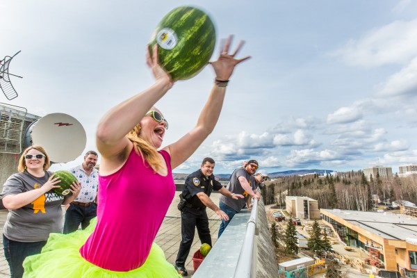 Senior Teal Rogers chucks a ripe watermelon from the roof of the Gruening Building on April 24 during the annual fruit drop signaling the start of the traditional SpringFest activities on the Fairbanks campus.