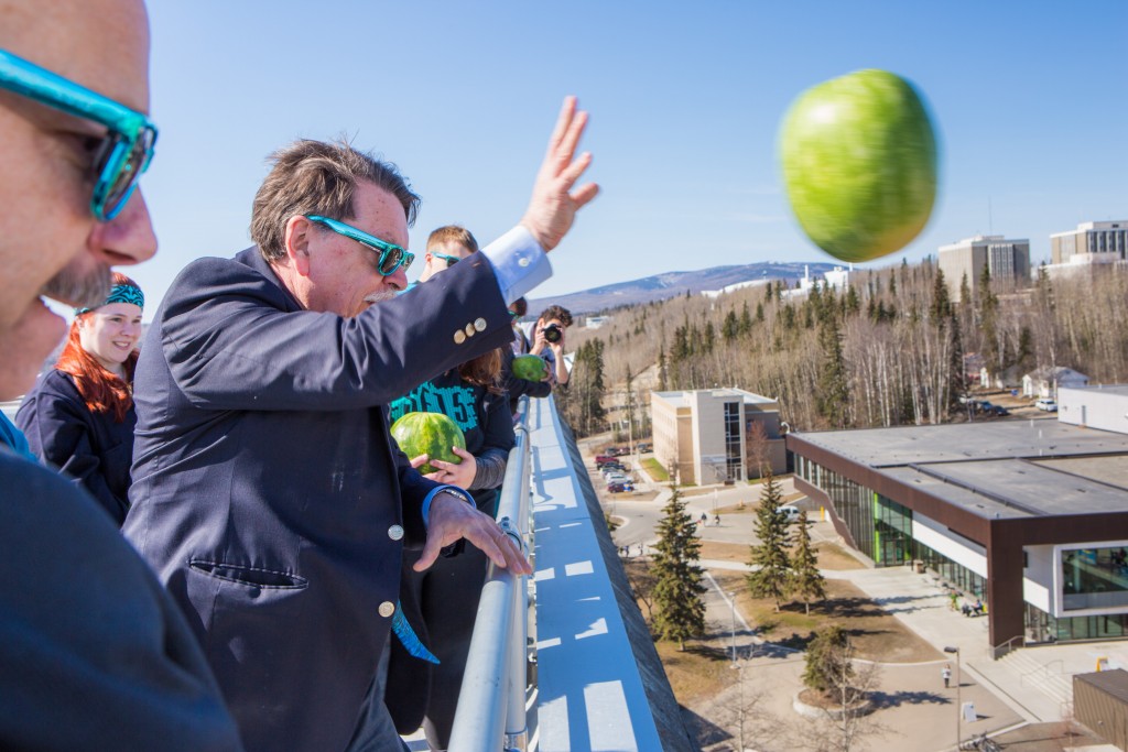 Chancellor Brian Rogers throws the first watermelon from the top of the Gruening Building on Thursday afternoon, kicking off Springfest 2015 on the Fairbanks campus. 
