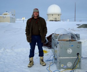 Photo by Carl Andersen. Carl Andersen stands next to imaging equipment in Fort Yukon during the 2010 launch of a sounding rocket from the Poker Flat Research Range. His team was testing out different techniques of releasing chemical tracers into the atmosphere to take measurements.