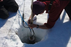 Photo by M. Truffer.  Bill Shaw  is attaching a thermistor string to measure ice temperatures. 