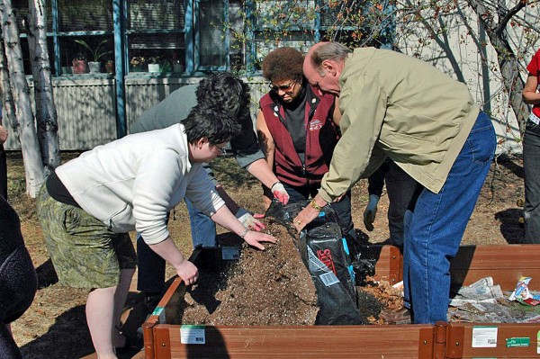 Cooperative Extension Service photo.  Participants in a past master gardener class build a raised bed for a lasagna garden. 