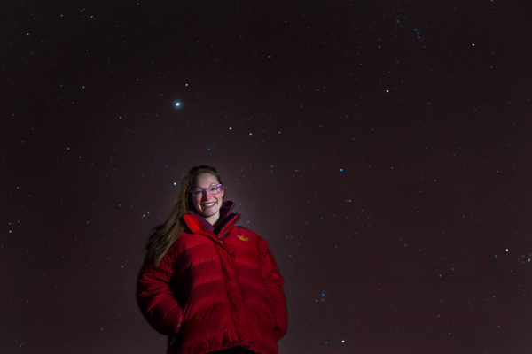 Photo by Todd Paris. Jessica Eicher stands against the background of a starry February night.