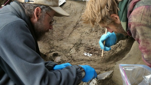 UAF photo courtesy of Ben Potter. University of Alaska Fairbanks professors Ben Potter and Josh Reuther excavate the burial pit at the Upward Sun River site.