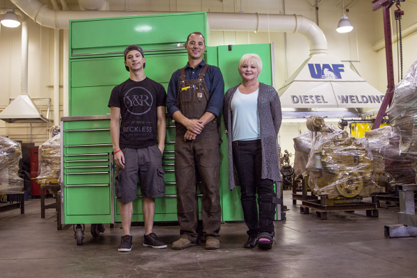 From left, Rodney Guffey, son of Marianne Guffey; Tony Simko, diesel and heavy equipment program coordinator; and Marianne Guffey pose in front of the tool box donated by the Guffey family to the Community and Technical College in memory of Marianne's late husband, Steve Guffey. UAF photo by Karalee Watts.