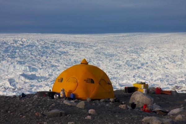 Photo by Martin Truffer..  A tent sits in camp on the edge of the Jakobshavn Isbræ in Greenland.