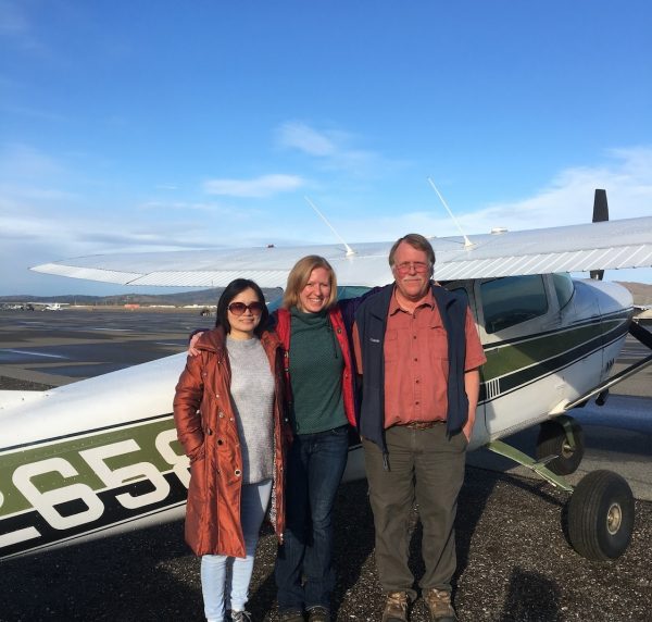 Photo by Kathy Lynch.  Project team (left to right) Sanmei Li, Jessica Cherry and Craig Kenmonth of AlphaAero pose in front of a Cessna.
