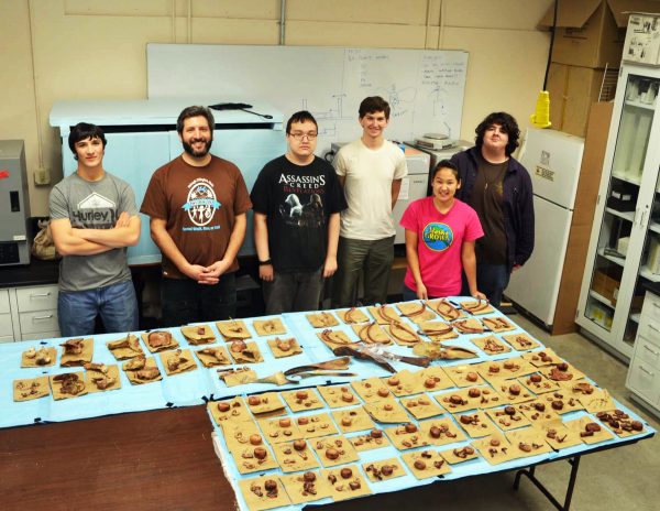 Bristol Bay Campus photo.  A group at Bristol Bay Campus — from left, Darren Napoli, Nathan Coutsoubos, Marshal Johnson, Christopher Marks, Mariah Dray and Eli Hunt — display the orca fetus bones they've cataloged in fall 2014.