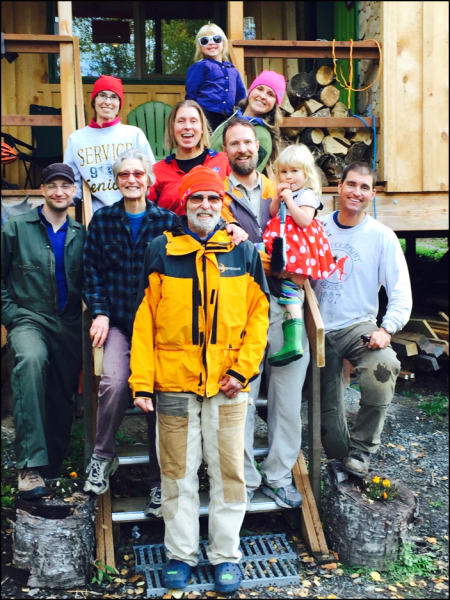 Courtesy of Erin Whitney.  Erin Whitney, center, poses with her family during a visit to their cabin south of Anchorage. Whitney studies solar power options for the Alaska Center for Energy and Power.