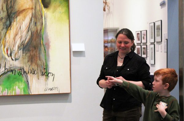 Photo by Peggy Hetman.  A volunteer docent talks with an elementary school student at the University of Alaska Museum of the North. No prior teaching experience is necessary to become a docent.