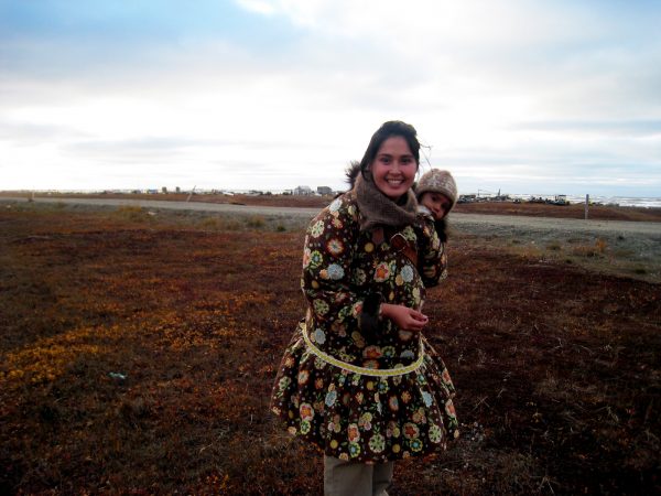 Evan Sterling photo.  Shaktoolik teacher Stacey Paniptchuk, pictured with her baby, Stefan, is part of a UAF partnership working to train more homegrown teachers in the Bering Strait School District. Click photo to download