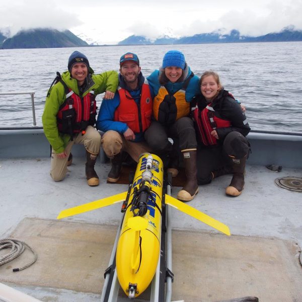 Photo courtesy of Claudine Hauri. From left, Andrew McDonnell, Hank Statscewich, Claudine Hauri and Brita Irving, gather by an autonomous glider used to measure carbon dioxide in the ocean. They were on the first sea trial out of Seward, a port on Alaska's southern coast.
