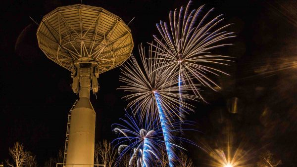 Fireworks illuminate the Alaska Satellite Facility's 11-meter antenna on West Ridge during the annual New Year's Eve Sparktacular.