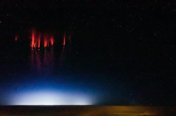 Jason Ahrns photo. Ahrns captured this photo of sprites or red lightning with his D7000 Nikon aboard the same flight where there was $100,000 worth of expensive camera equipment that could shoot 10,000 frames per second.