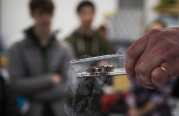 Meghan Murphy photo.  A levitating superconductor shows the properties of quantum physics in a demonstration for high school and college students.