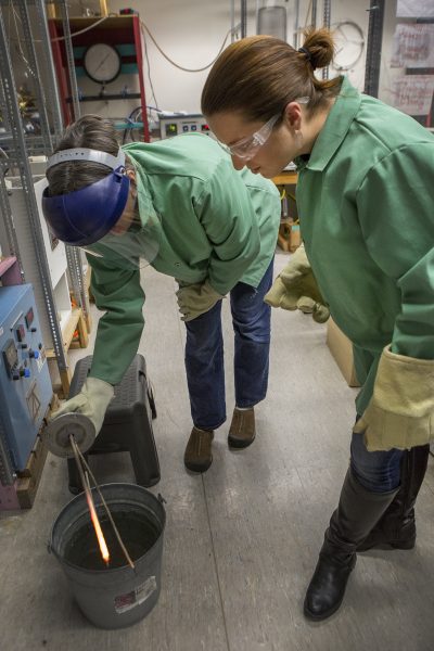 Photo by Meghan Murphy. UAF geosciences Professor Jessica Larsen helps doctoral student Sarah Black, from the University of Colorado Boulder, cool synthetic Martian lava into volcanic rock.