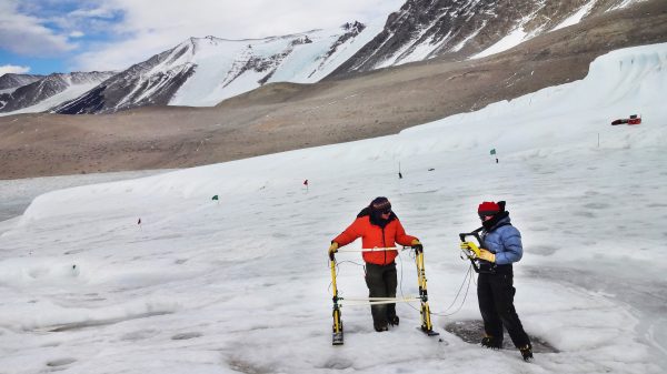 Photo by Jessica Badgeley. University of Alaska Fairbanks glaciologist Erin Pettit, left, and graduate student Christina Carr collect radar data on Taylor Glacier.
