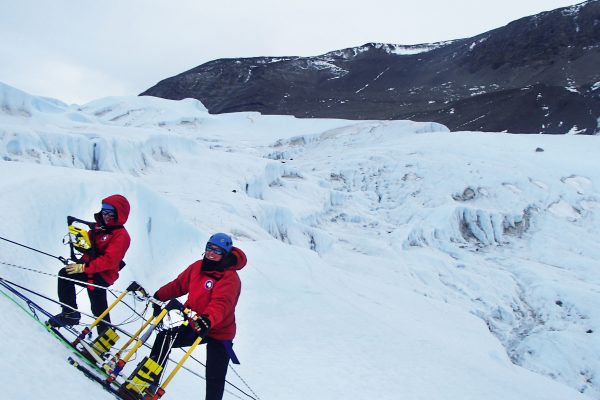 Photo by Cece Mortenson. Christina Carr, left, and Jessica Badgeley collect radar data to map the pathway of salty water that connects Blood Falls to the source of water underneath the glacier.