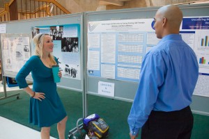 Psychology  major Jordyn Montgomery discusses results of her research project on body image and eating disorders with a colleague during the Research Day poster session in the Wood Center.