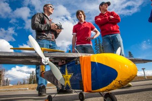 Engineering student Corey Upton handles the remote controller while fellow team members Kyle Emery, center, and club president David Apperson stand by during a demonstration flight of their model airplane. The group designed and built the four-foot wingspan plane and competed in a national contest in April in Wichita, KS.