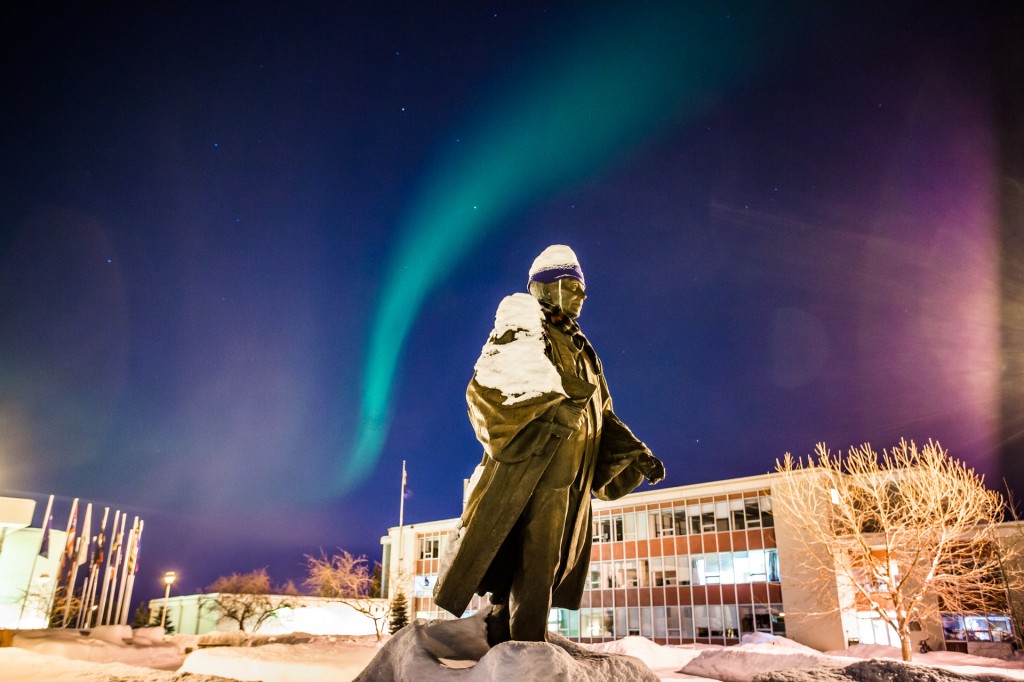 Another beautiful aurora display highlights the statue of UAF's first president, Charles Bunnell, and the building named after him on the Fairbanks campus. Thoughtful students occasionally cover him up from the winter chill.