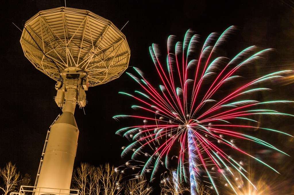 Fireworks explode near the Alaska Satellite Facility's new 11-meter antenna on UAF's West Ridge during the annual New Year's Eve Sparktacular event sponsored by local businesses.