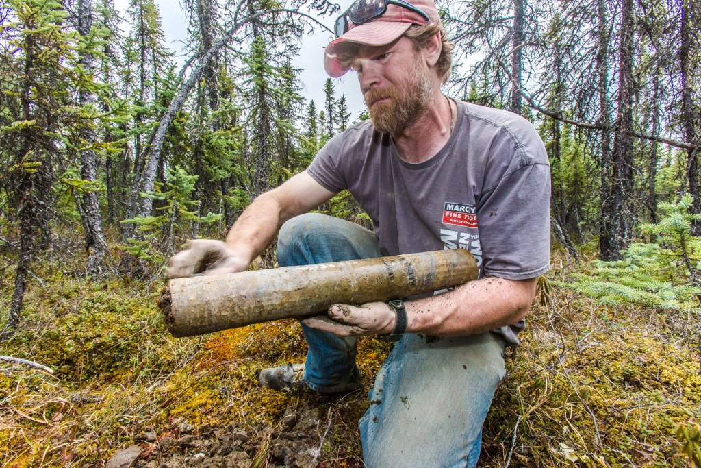 Jamie Hollingsworth, site manager for the Bonanza Creek Long Term Ecological Research site, scrapes mud from a permafrost core sample freshly unearthed from a depth of about 8 feet. Hollingsworth and his colleagues were collecting samples from a black spruce forest near the Tanana River about 25 miles southwest of Fairbanks.    