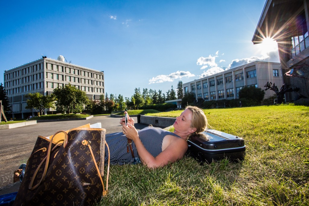 Lisa Ibias, a guest faculty member for the 2015 Fairbanks Summer Arts Festival, takes a break to enjoy some glorious weather before another performance in the Davis Concert Hall. Ibias is the concert master of the Juneau Symphony.