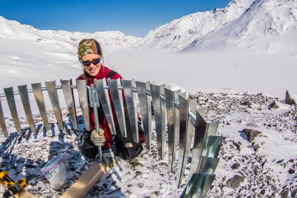 <i>UAF photo by Todd Paris.</i><br /> UAF researcher Anna Liljedahl puts up a wind shield around a gauge that she installed on Jarvis Glacier to measure rainfall. 