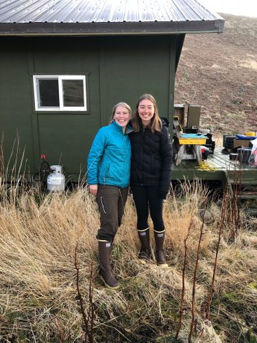 <i>Photo by Heather Renner, Alaska Maritime National Wildlife Refuge</i><br>Biologists Briana Bode, left, and Katie Stoner pose after being dropped off at their cabin on Chowiet Island in May 2021. The women recently experienced a magnitude 8.2 earthquake there, not far from the epicenter. 